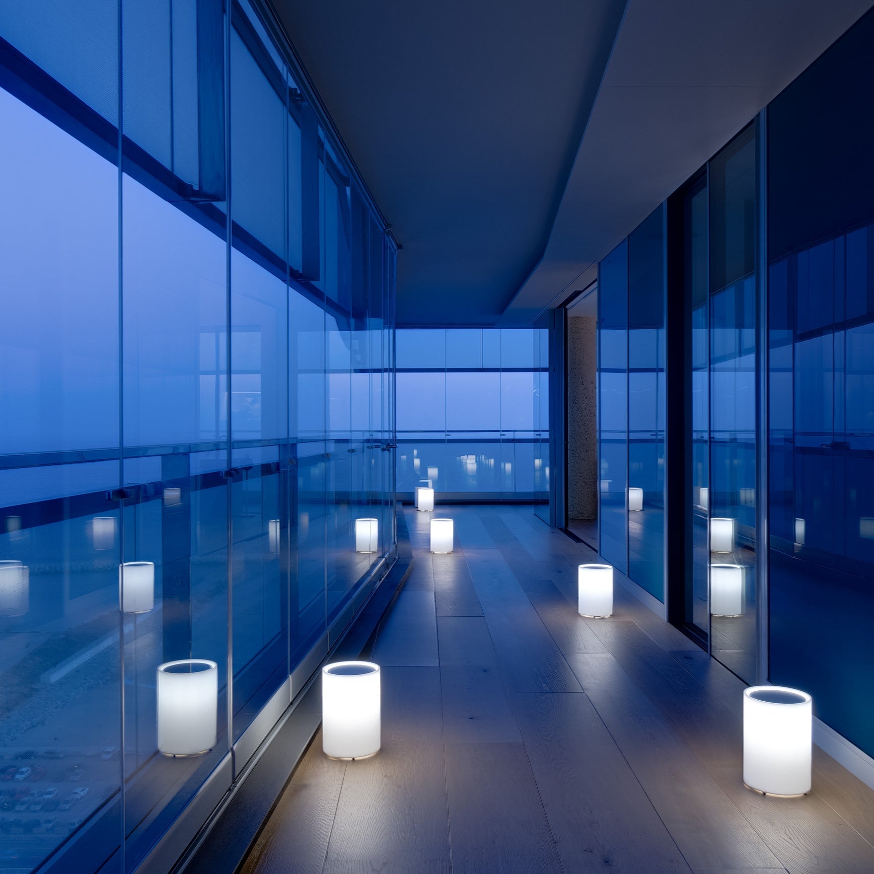Lenta Floor Light on timber floor with glass walls