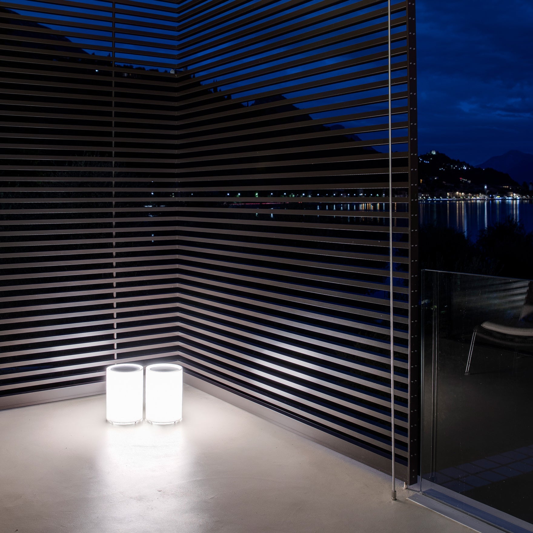 Lenta Floor Lights on concrete floor set against slatted wall