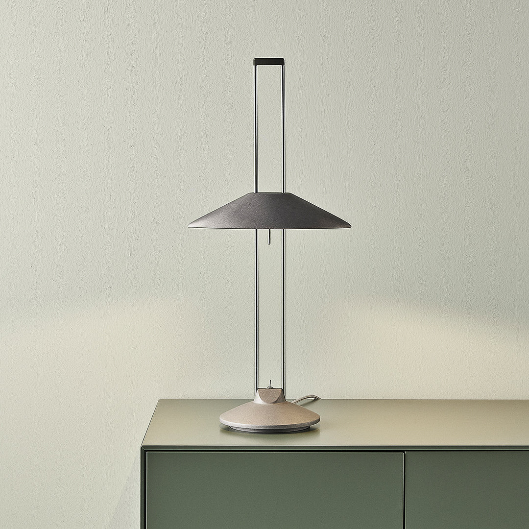 Adjustable metal table lamp on sideboard