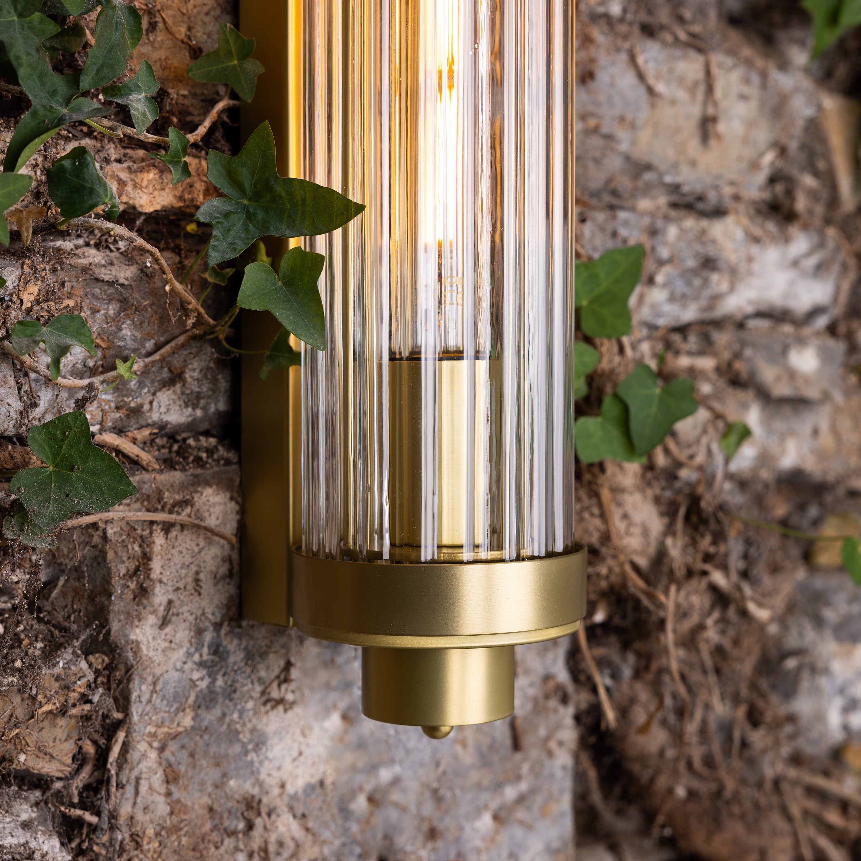 Retro Bathroom wall light fixture in Satin Brass on a rustic wall - detail