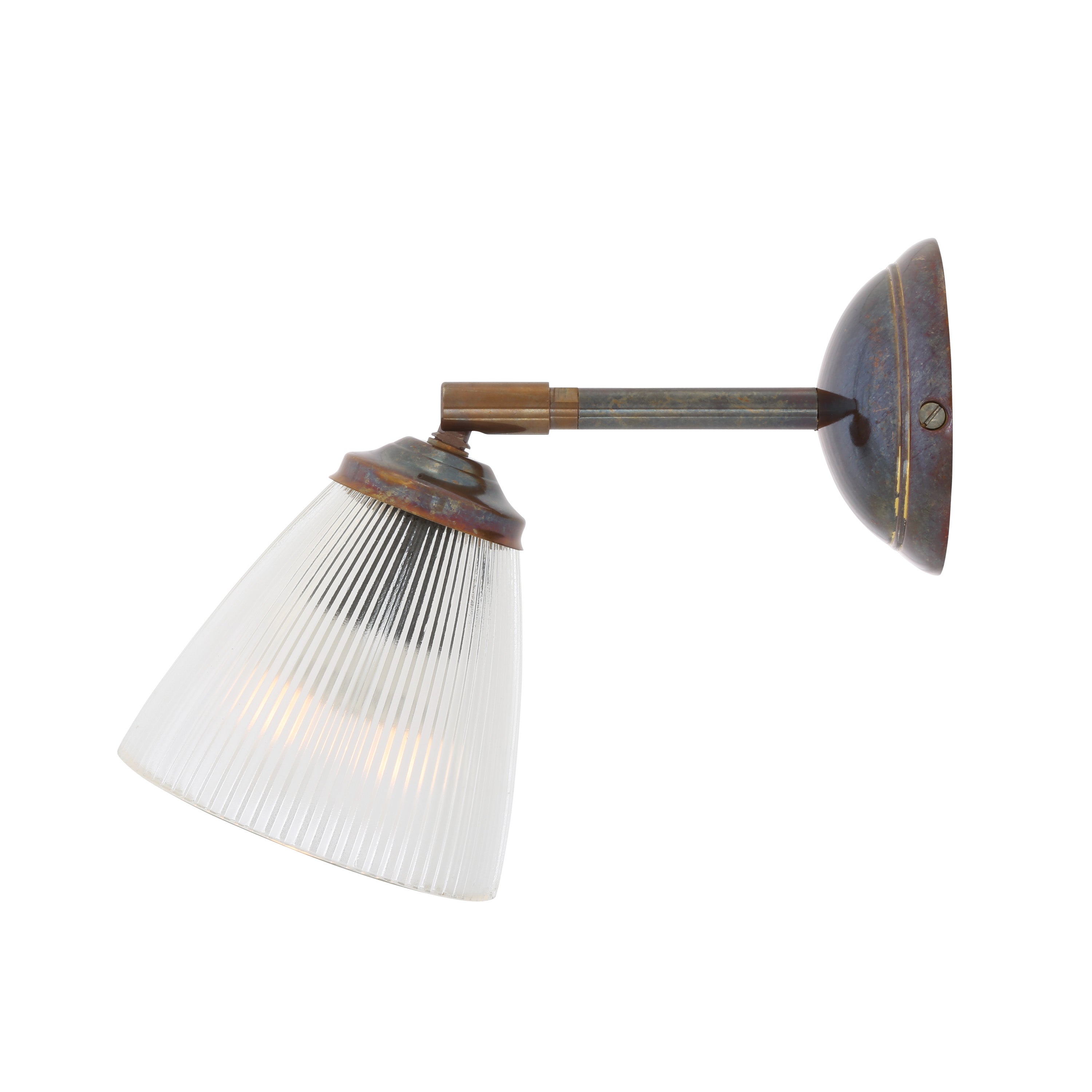 Wall-mounted light fixture in antique brass with prismatic glass shade on a white background