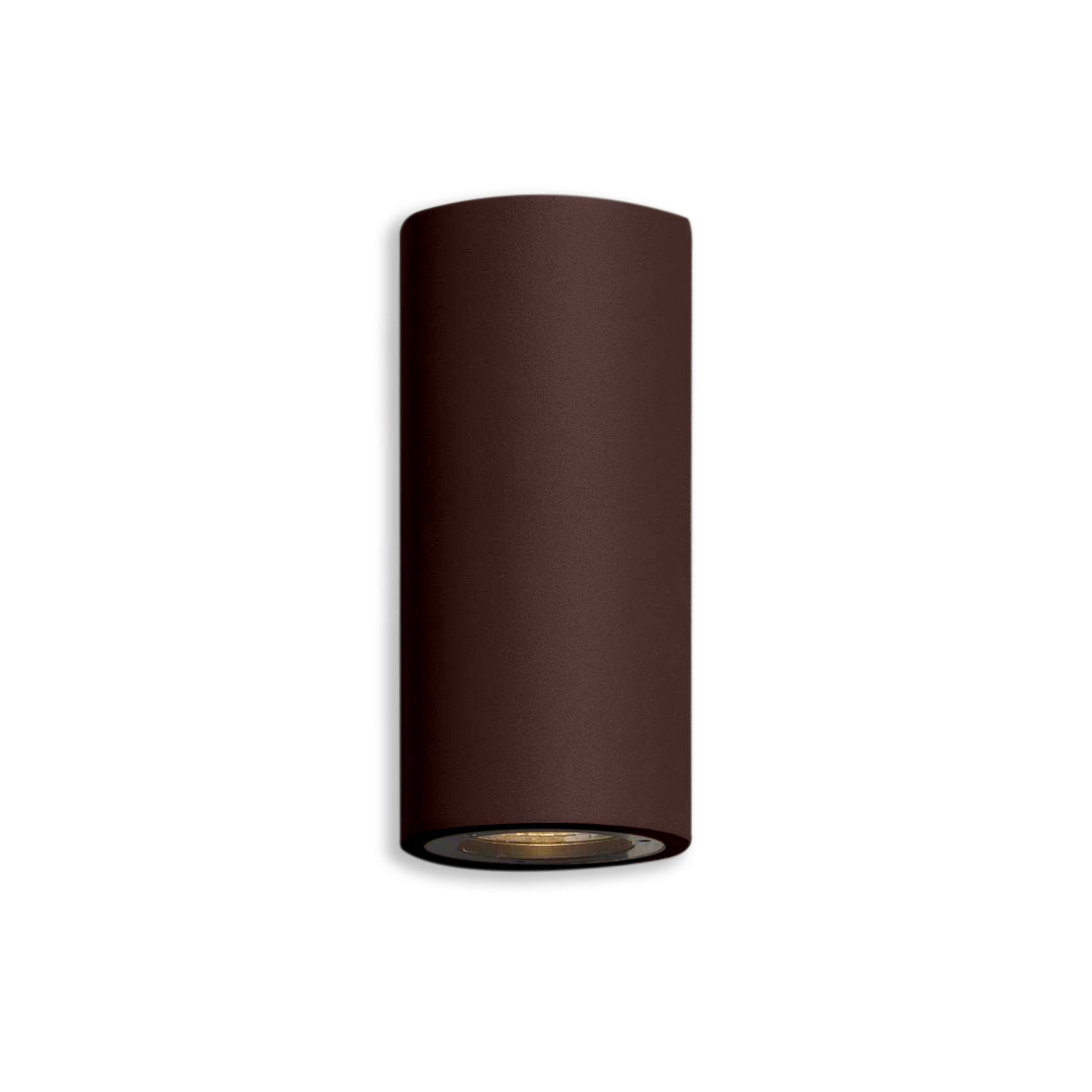 Cylindrical rust effect light fixture on a white background