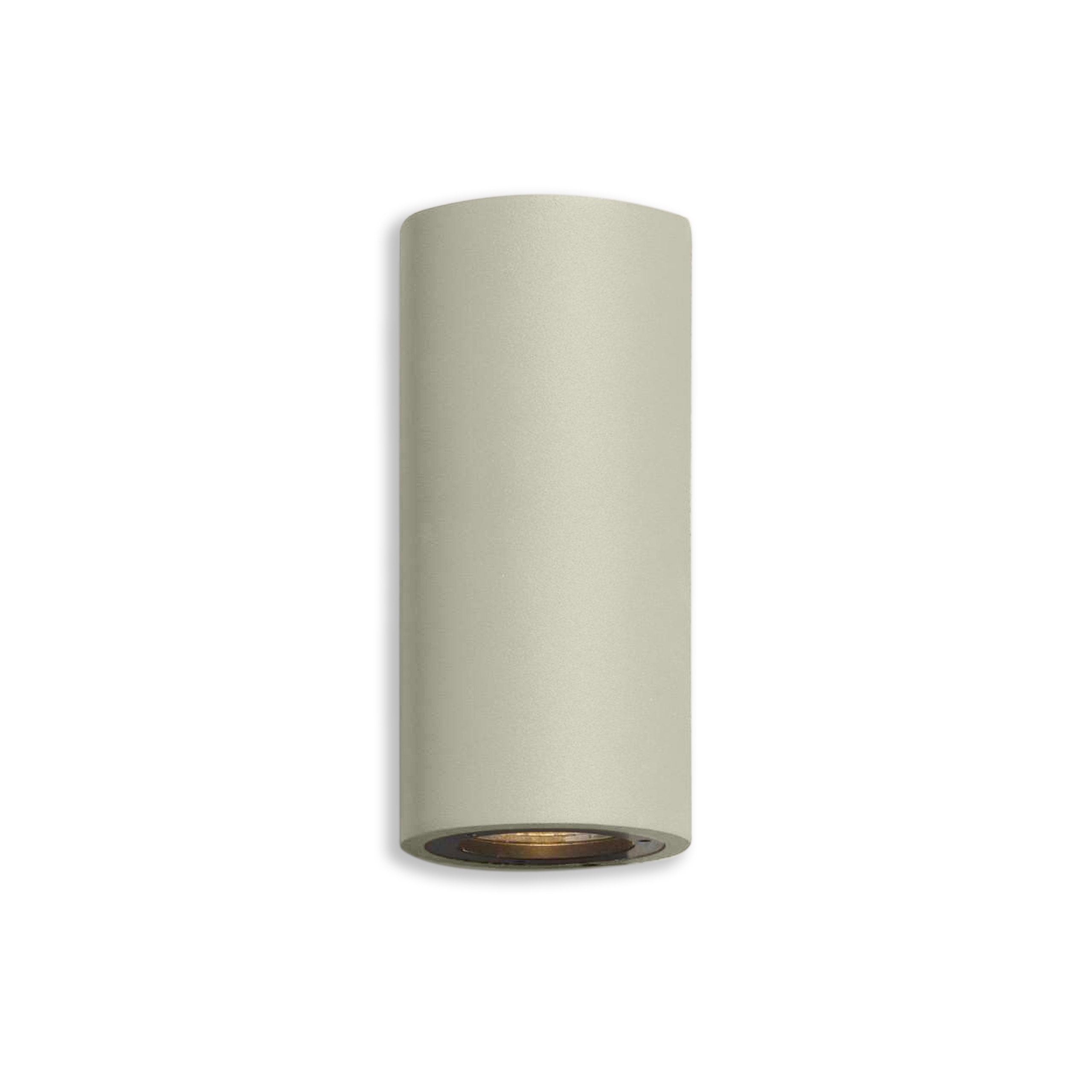 Cylindrical sand coloured light fixture on a white background