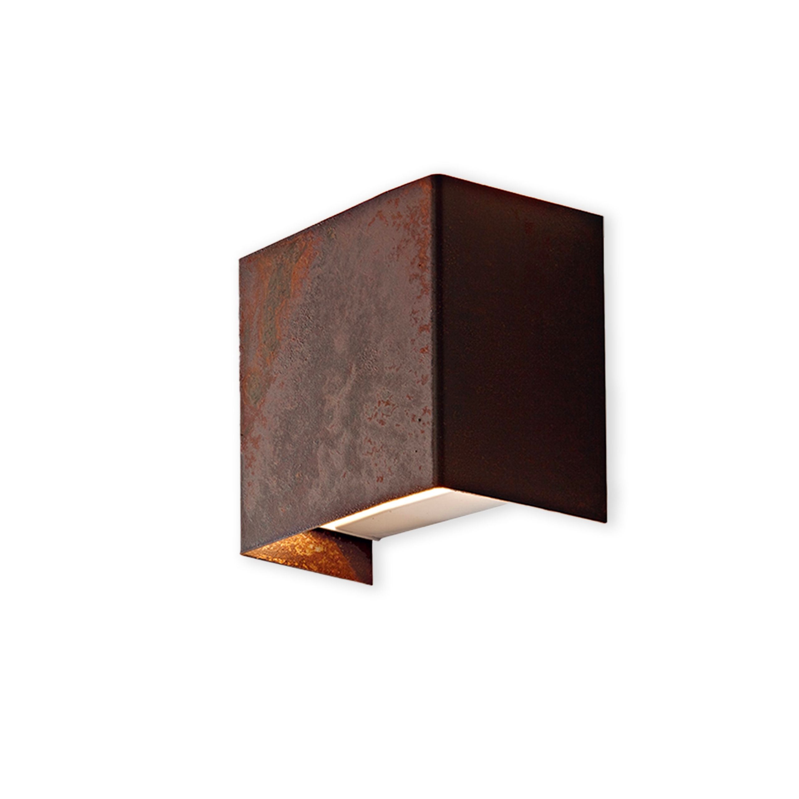 Corten textured finish wall-mounted light fixture on a white background