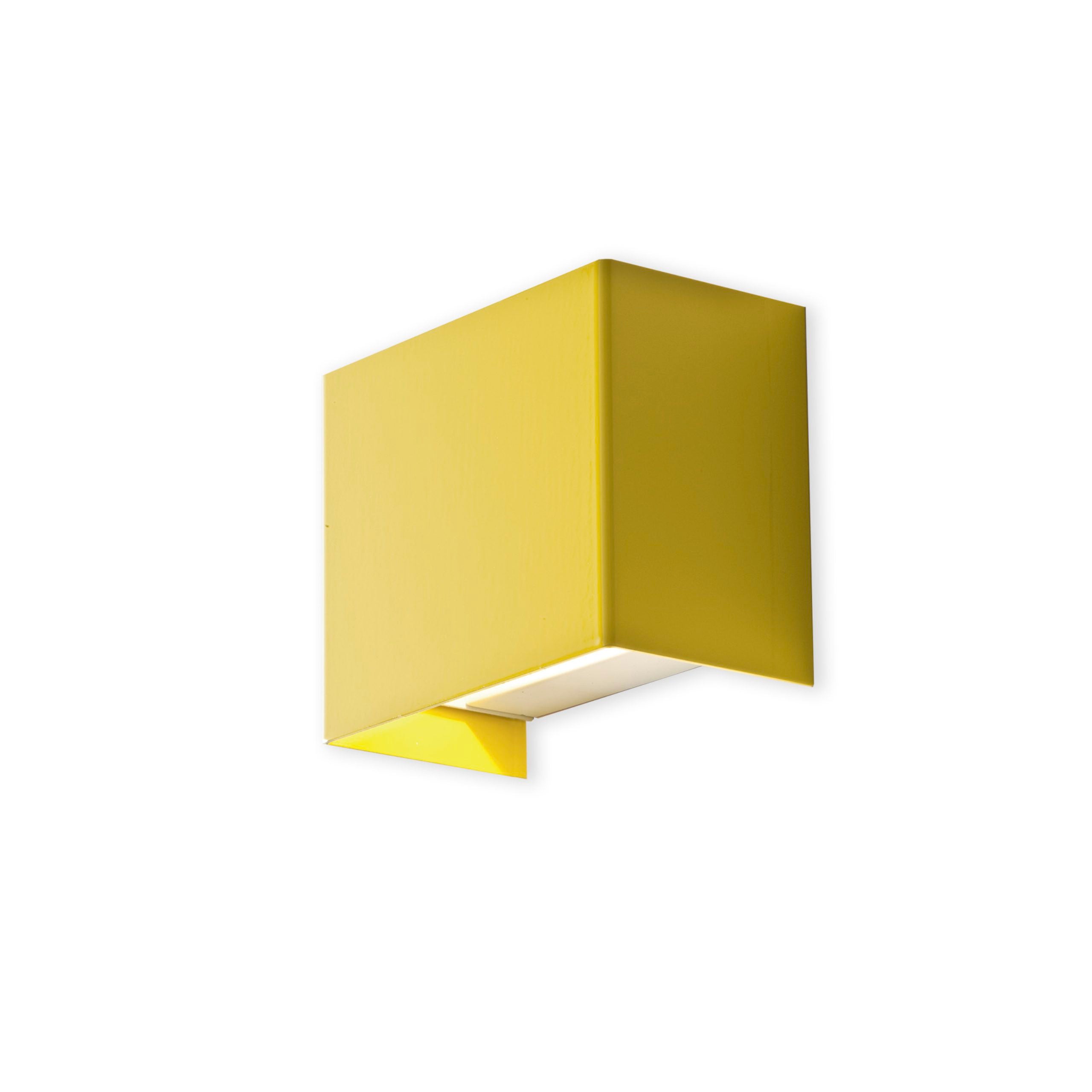 Yellow wall-mounted light fixture on a white background