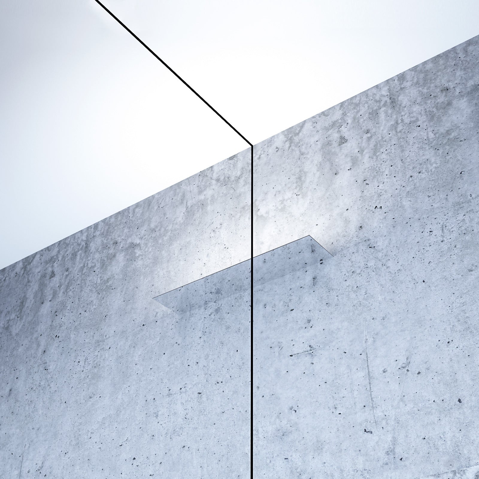 Mirror finished LED wall light on concrete wall