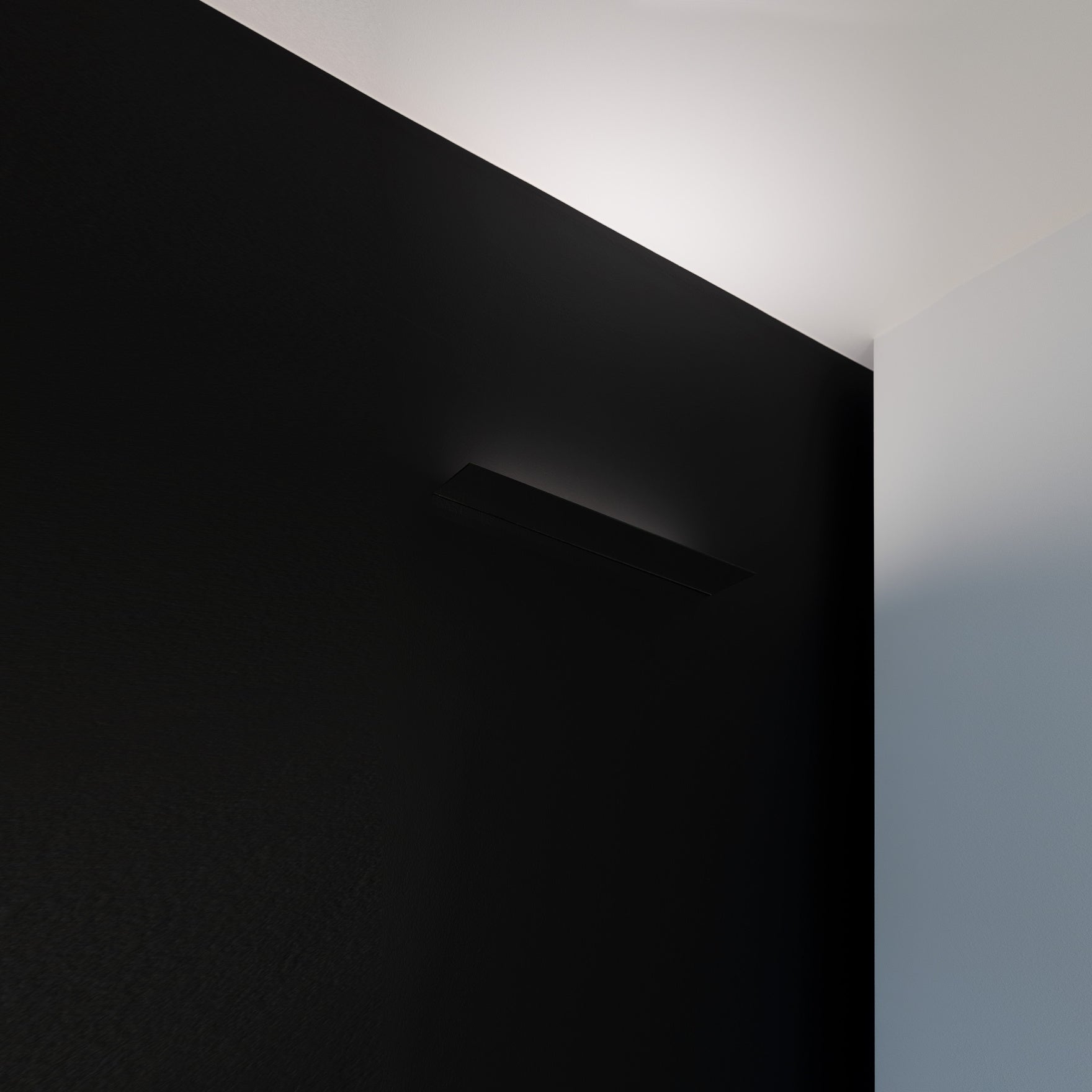 Mirror finished LED wall light on black wall