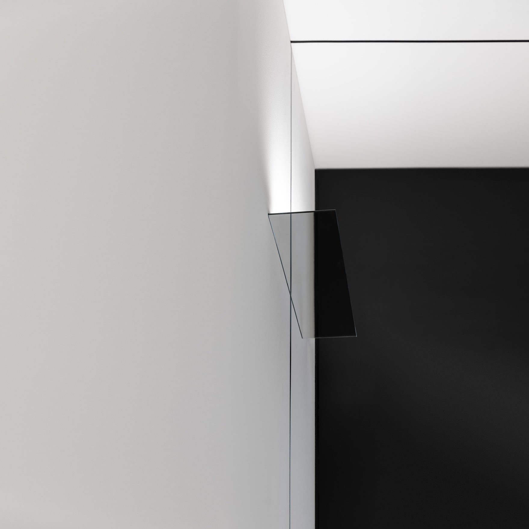 Mirror finished LED wall light on white wall