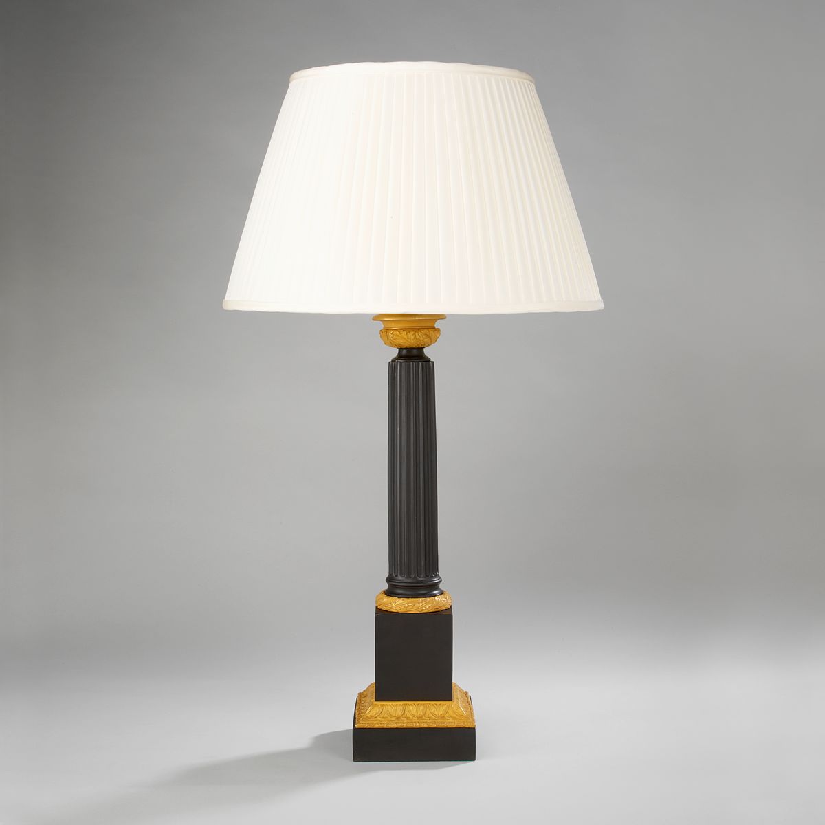 Bronze and gilt column lamp with cream silk shade