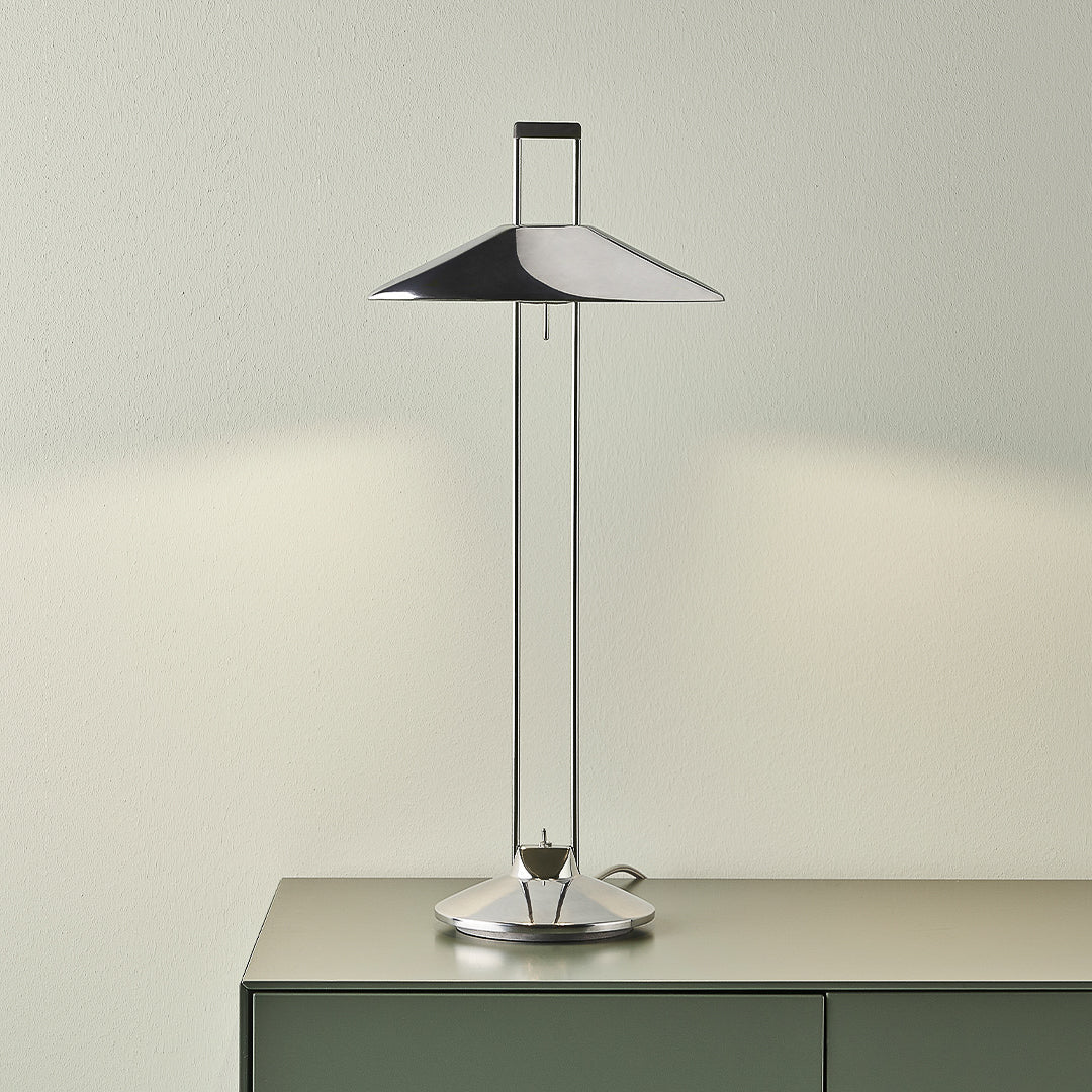 Adjustable metal table lamp on sideboard