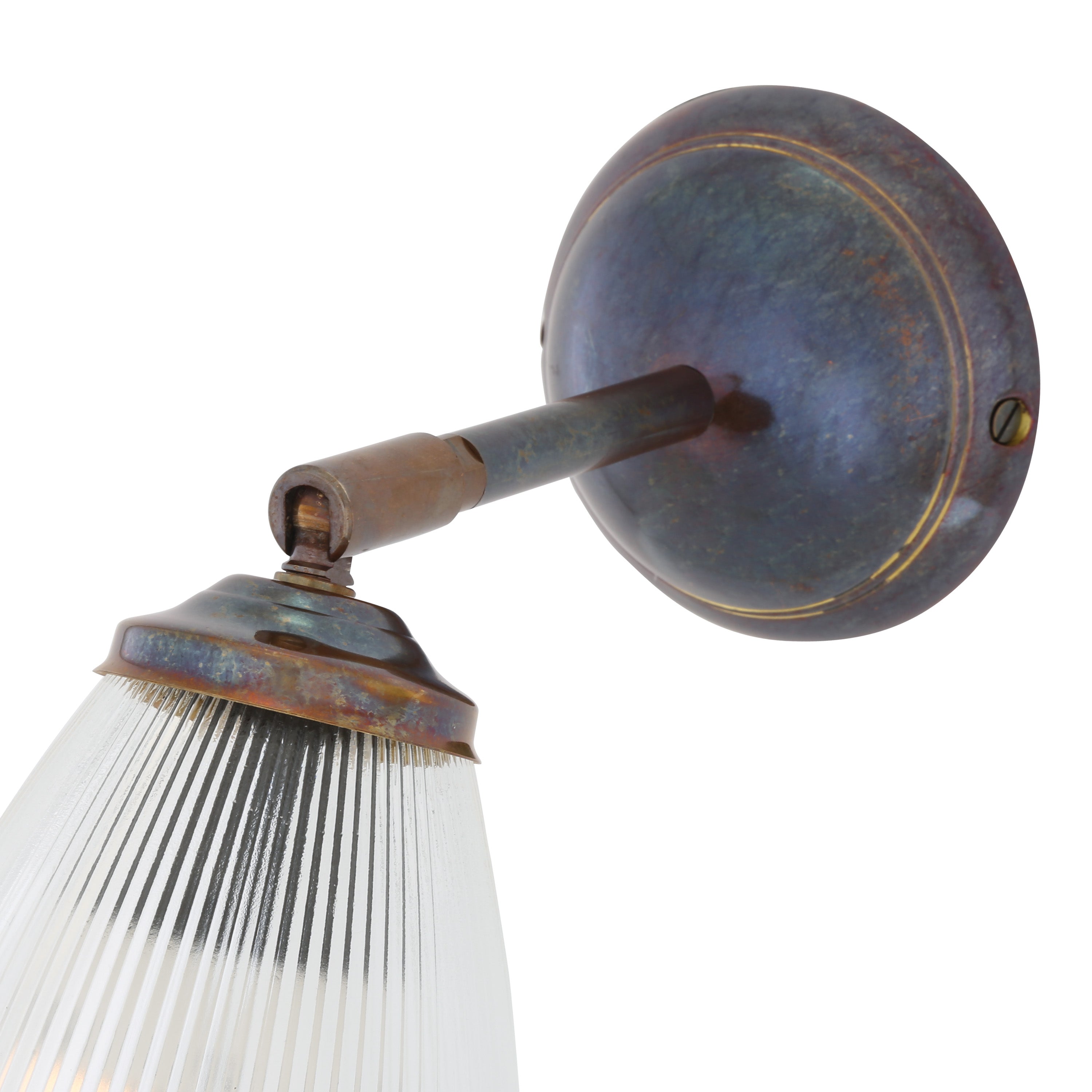 Wall-mounted light fixture in antique brass with prismatic glass shade on a white background